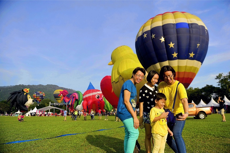 Visitors taking selfies in front of the uniquely-shaped balloons.