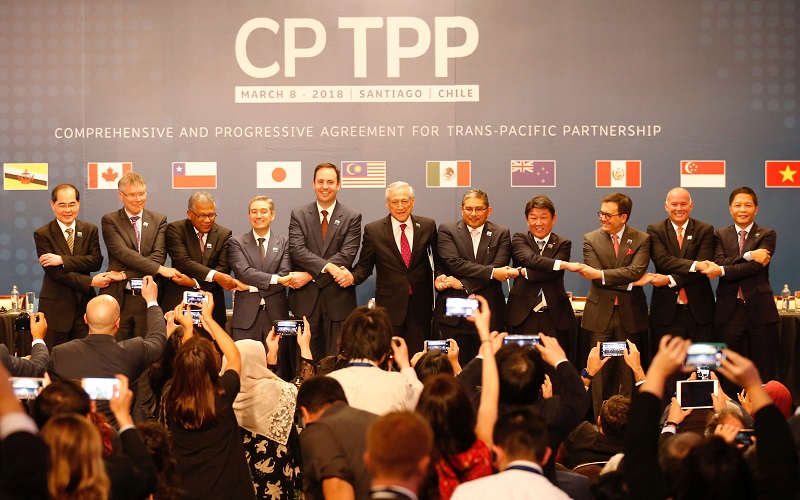 Representatives of members of Trans-Pacific Partnership (TPP) trade deal wave as they pose for an official picture after the signing agreement ceremony in Santiago, Chile March 8, 2018. u00e2u20acu201d Reuters pic 