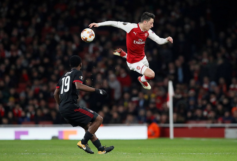 Arsenalu00e2u20acu2122s Mesut Ozil (right) in action with AC Milanu00e2u20acu2122s Franck Kessie at the Emirates Stadium in London March 15, 2018. u00e2u20acu201d Reuters pic