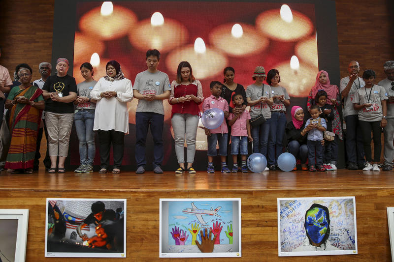 Relatives of flight MH370 observe a minute of silence during the 4th annual remembrance event at the Publika in Kuala Lumpur March 3, 2018. u00e2u20acu201d Picture by Yusof Mat Isa