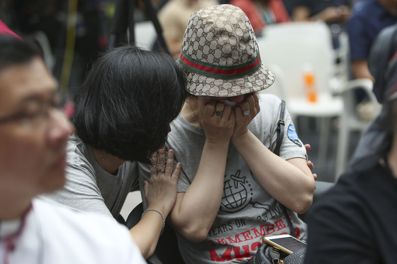 Jing Hong Xu, a relative of one of the passengers of flight MH370, cries during the 4th annual remembrance event at the Publika in Kuala Lumpur March 3, 2018.