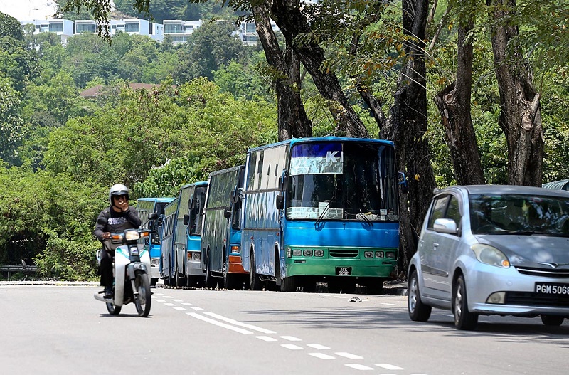 Factory buses parked at the side of the road in Relau March 6, 2018. u00e2u20acu201d Picture by Sayuti Zainudin