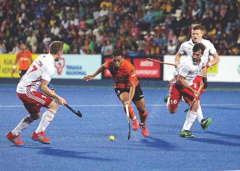 Firhan Ashari trying to dribble past England players. u00e2u20acu201d Picture by Farhan Najib