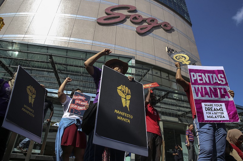 People hold up posters as they take part in a march to commemorate International Womenu00e2u20acu2122s Day 2018 in Kuala Lumpur March 10, 2018. u00e2u20acu201d Picture by Yusof Mat Isa