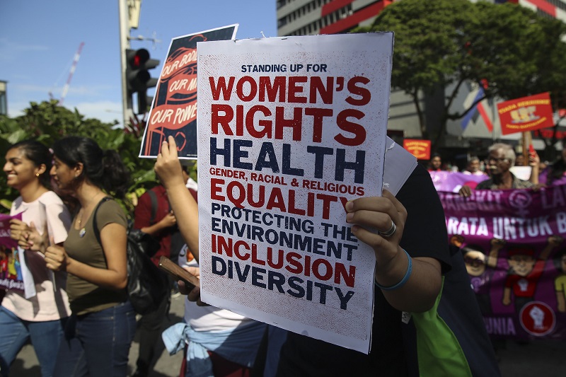 A woman holds up a poster on women's rights as she takes part in a march to commemorate International Womenu00e2u20acu2122s Day 2018 in Kuala Lumpur March 10, 2018. u00e2u20acu201d Picture by Yusof Mat Isa
