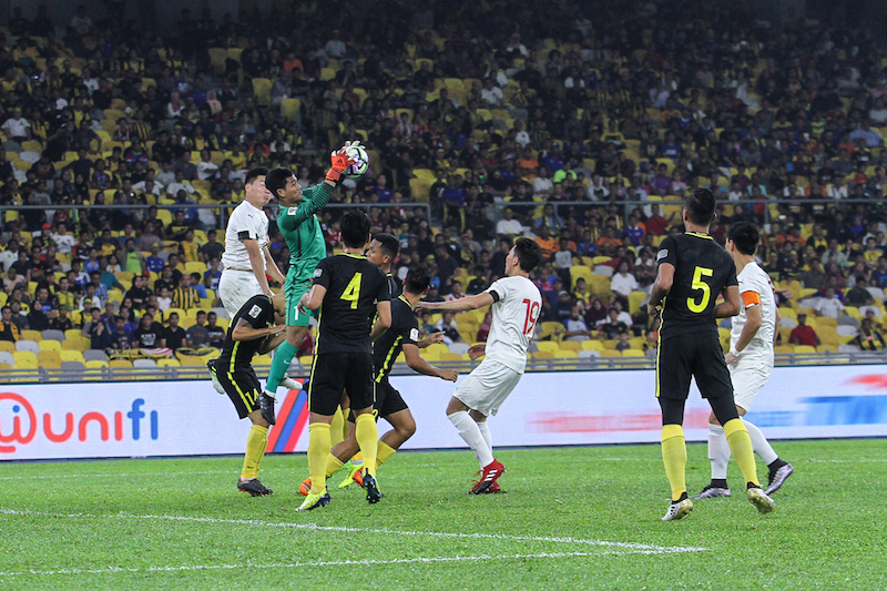 Malaysia goalkeeper, Haziq Nadzli, saves an attempt at goal during the International friendly with Mongolia at the Bukit Jalil National Stadium in Kuala Lumpur March 22, 2018. u00e2u20acu201d Picture by Shafwan Zaidon