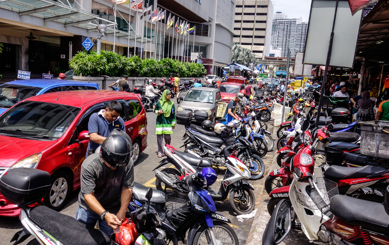 Cars and motorcycles park at a restricted area at Jalan Raja Alang. Traffic offences such as this are also on the rise. 