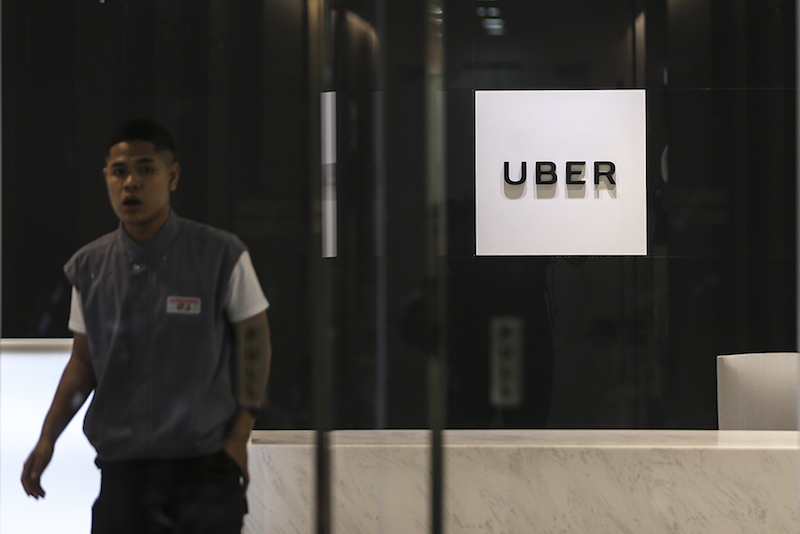 A man walks past the Uber Customer Service Office in Bangsar South March 27, 2018. u00e2u20acu201d Picture by Azneal Ishak