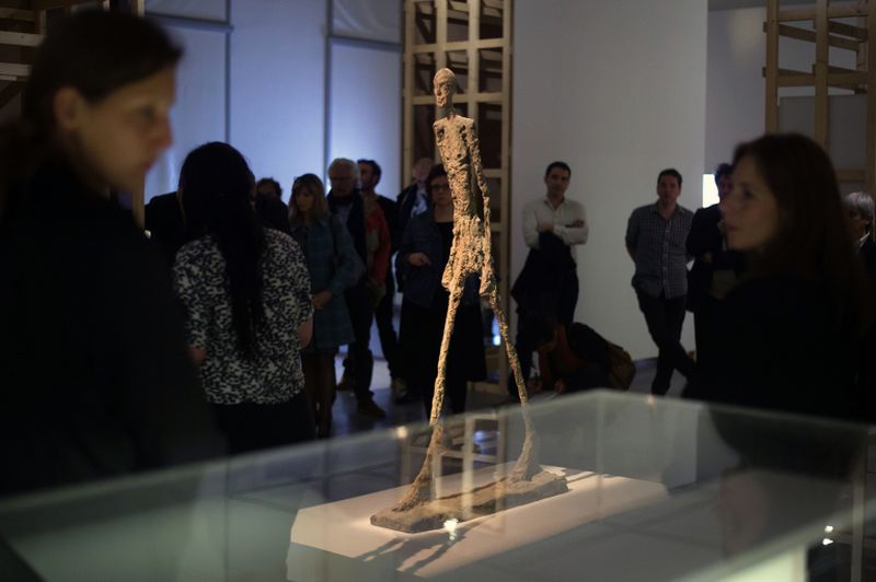 Visitors look at a sculpture entitled 'En marche' by Swiss artist Alberto Giacometti during the exhibition u00e2u20acu02dcJean Genet, l'echappee belleu00e2u20acu2122 at the Museum of European and Mediterranean Civilisations (MUCEM) in Marseille April 15, 2016. u00e2u20acu2022 AFP pic