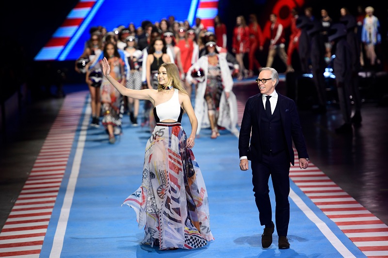 US model Gigi Hadid (left) and US fashion designer Tommy Hilfiger, acknowledge the audience at the end of the womenu00e2u20acu2122s Fall/Winter 2018/2019 collection fashion show by Tommy Hilfiger in Milan February 25, 2018. u00e2u20acu201d AFP pic