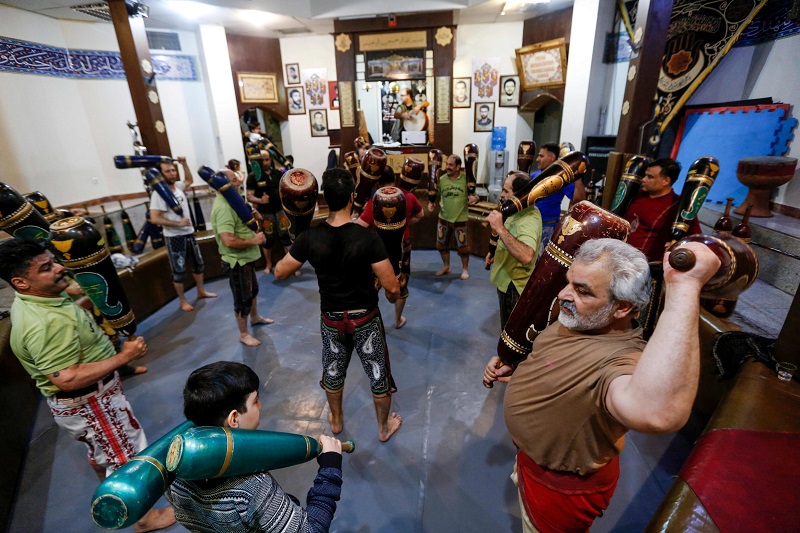 Iranians train with wooden clubs during a workout session at the traditional Shir Afkan ‘zurkhaneh’ (House of Strength) gymnasium in the capital Tehran February, 27, 2018. — AFP pic