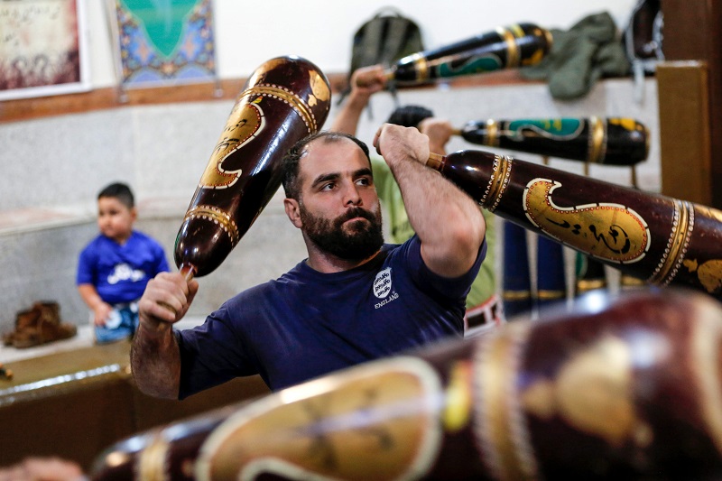 An Iranian trains with wooden clubs during a workout session at the traditional Shir Afkan u00e2u20acu02dczurkhanehu00e2u20acu2122 (House of Strength) gymnasium in the capital Tehran February, 27, 2018. u00e2u20acu201d AFP pic