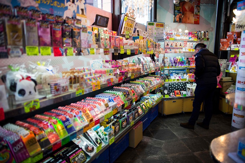In this picture taken on February 5, 2018, a man looks at the condoms displayed in a Condomania condom shop at Harajuku district in Tokyo. u00e2u20acu201d AFP pic