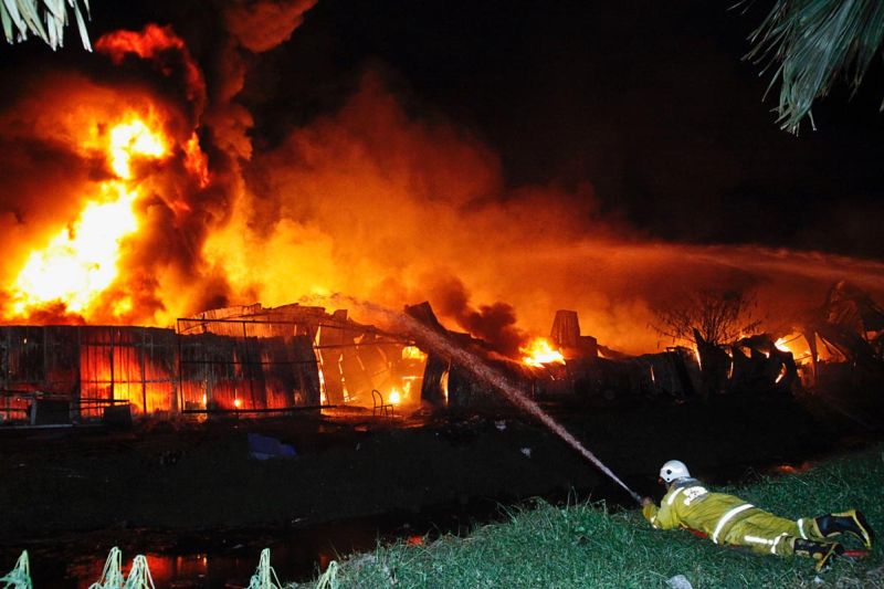Firemen are seen putting out the fire which engulfed four factories near the Penang International Airport, March 29, 2018. u00e2u20acu2022 Picture by Sayuti Zainudinn