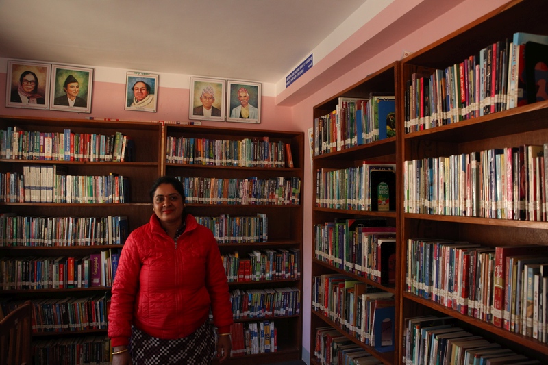 Meera Marahattha stands surrounded by books in the Tribeni community library in Bhimdhunga, Nepal February 9, 2018. u00e2u20acu201d Reuters pic