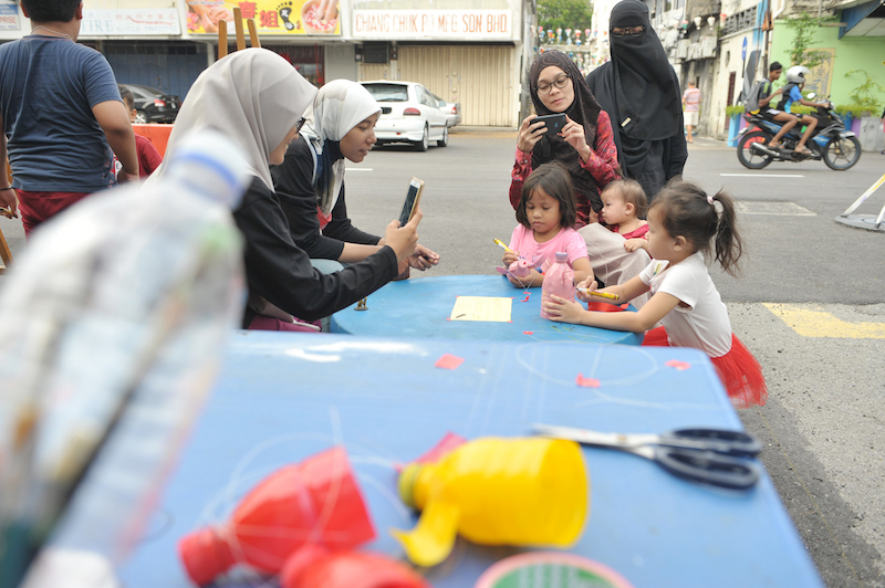 Children learn to make dog lanterns in conjunction with Chinese New Year at the Art Kiddo corner of the Butterworth Art Walk. — Picture by KE Ooi