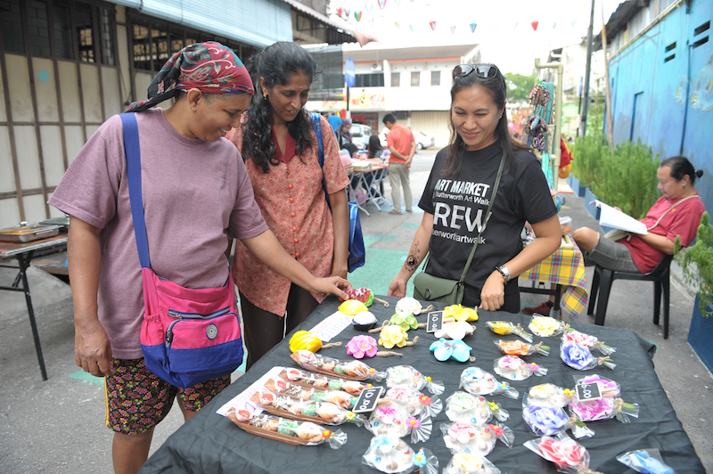 Customers look at handmade soaps at the Butterworth Art Market. — Picture by KE Ooi