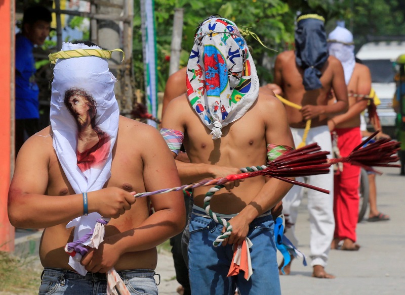 Hooded penitents perform self-flagellation to atone for their sins during Good Friday Lenten rites in Cutud town, Pampanga province, north of Manila, Philippines March 30, 2018. u00e2u20acu201d Reuters pic