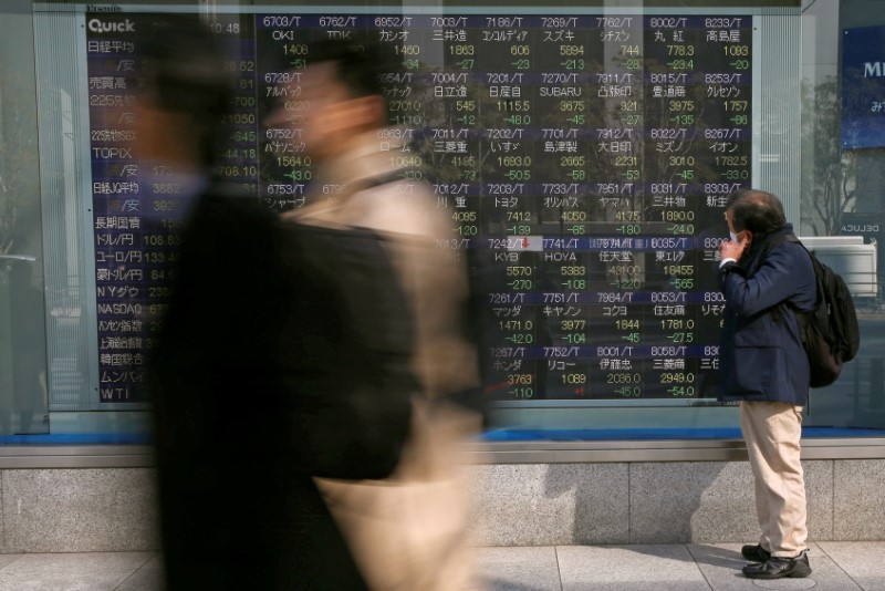 A man looks at an electronic stock quotation board outside a brokerage in Tokyo February 9, 2018. u00e2u20acu201d Reuters pic