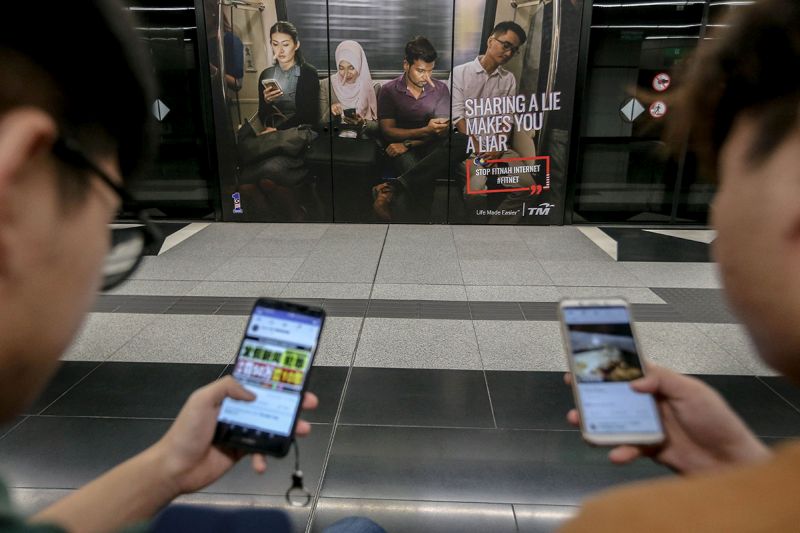 An advertisement discouraging the dissemination of fake news is pictured at a train station in downtown Kuala Lumpur March 26, 2018. — Picture by Hari Anggara