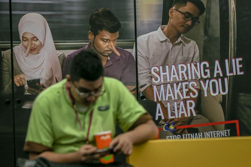 An advertisement discouraging the dissemination of fake news is pictured at a train station in downtown Kuala Lumpur March 26, 2018. u00e2u20acu201d Picture by Hari Anggara
