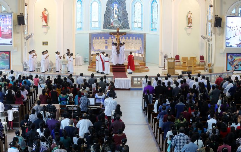 Servers carry the cross onto the altar at the Church of Our Lady of Lourdes, Ipoh on Good Friday March 30, 2018. u00e2u20acu2022 Picture by Farhan Najib
