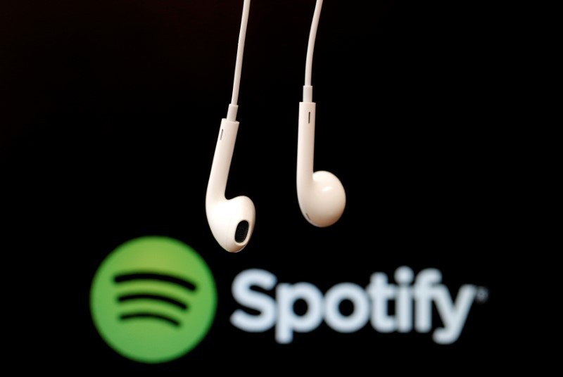 Headphones are seen in front of a logo of online music streaming service Spotify in this February 18, 2014 illustration picture. u00e2u20acu201d Reuters pic
