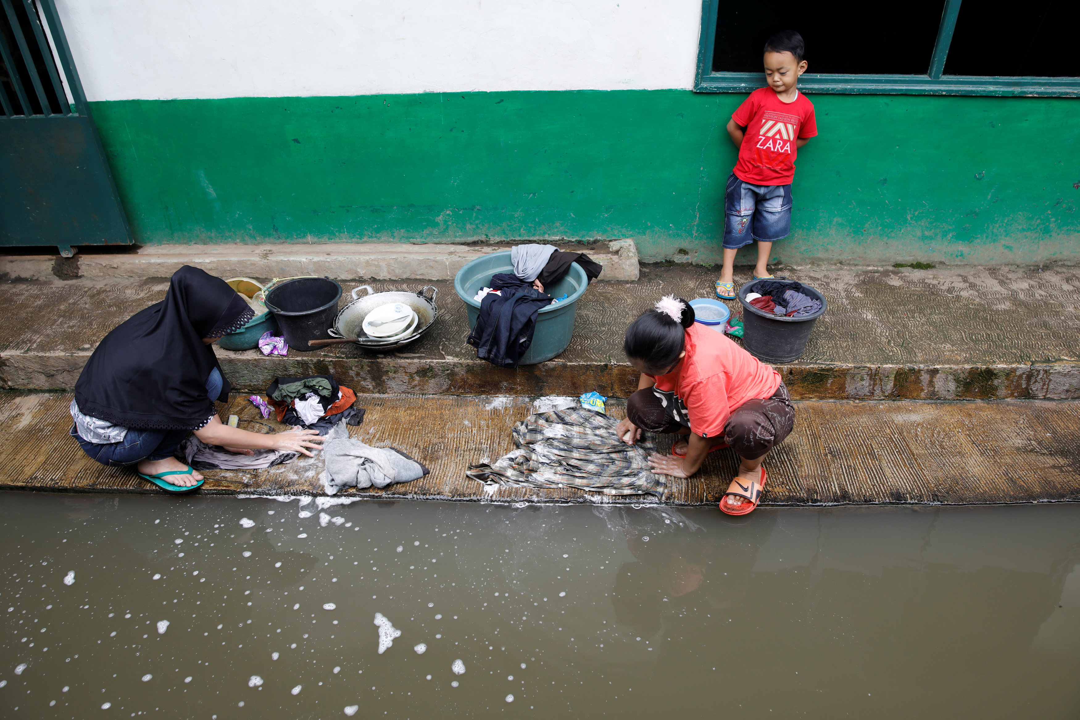 Women wash clothes in water from a tributary of the Citarum river in Majalaya, a town densely populated with textile factories, south-east of Bandung, West Java province, Indonesia, January 25, 2018. u00e2u20acu201d Reuters pic