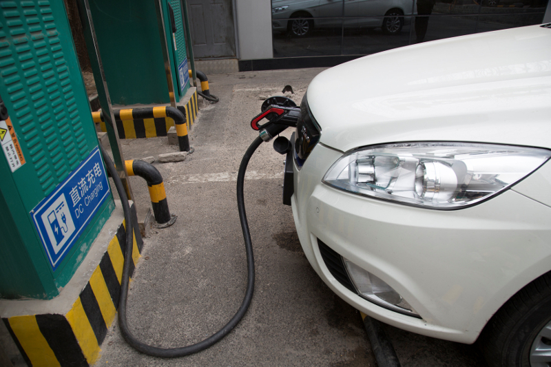 A charging cable is seen hooked to a car at a State Grid Corporation of China charging point for electric vehicles in Beijing March 3, 2018. u00e2u20acu201d Picture by Reuters/Stringer