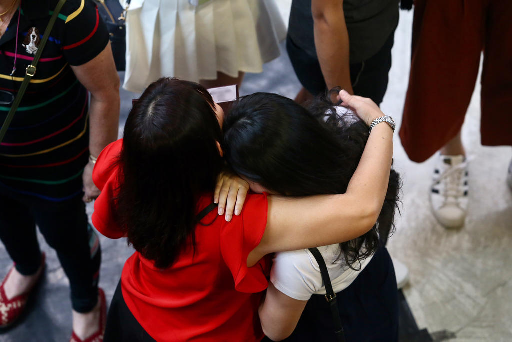 A student being consoled at Nanyang JC after receiving a slip of paper informing them of a briefing that they were affected by the theft of the GCE A-Level H2 Chemistry paper 3 examination scripts. u00e2u20acu201d TODAY pic