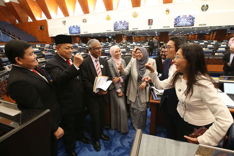 Datuk Seri Shahidan Kassim and Teresa Kok pretend to fight after the last session of the 13th Parliament. — Picture by Azinuddin Ghazali