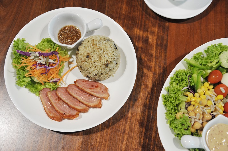 Olive rice with smoked duck and salad (right) at De Lawn. 
