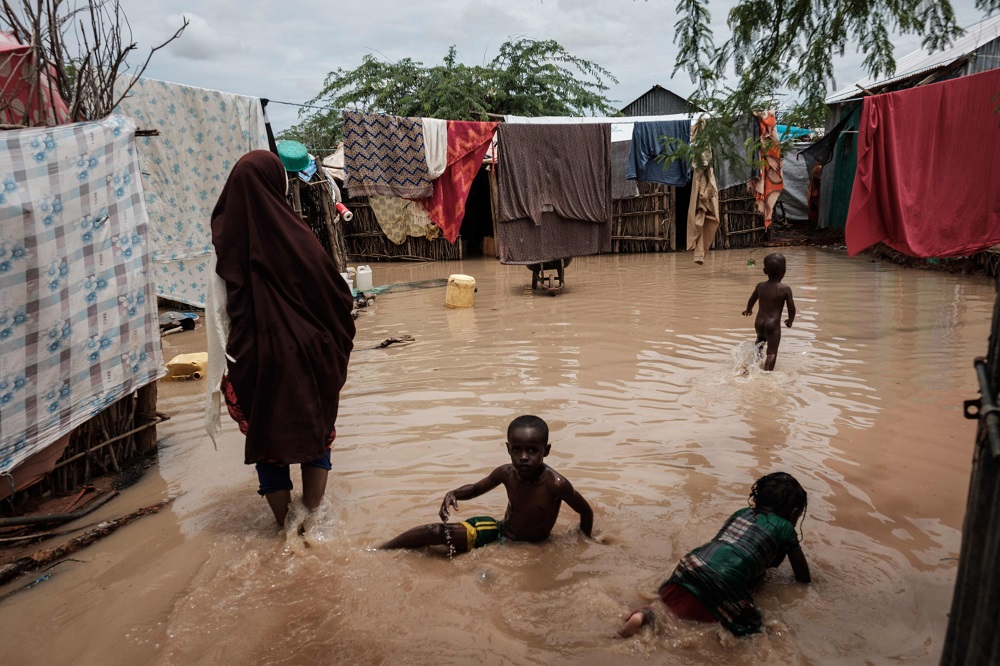 Children play in floodwaters after a heavy rainy season downpour as they seek to fill sandbags at the Dadaab refugee complex, in the north-east of Kenya April 17, 2018. u00e2u20acu201d AFP pic