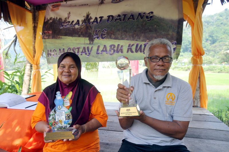 Kampung Labu Kubong village chief Meor Samsudin Abu Hassan (right) and homestay operator Fatimah Dollah.  Meor Samsudin believes homestays have boosted the local economy. — Picture by Farhan Najib