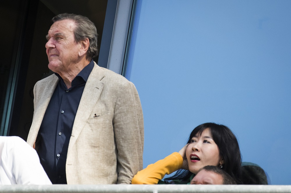 Former German Chancellor Gerhard Schroeder and Kim So-Yeon watch the German first division Bundesliga football match between Hannover 96 vs Bayern Munich in Hanover, central Germany, on April 21, 2018. u00e2u20acu201d AFP picn