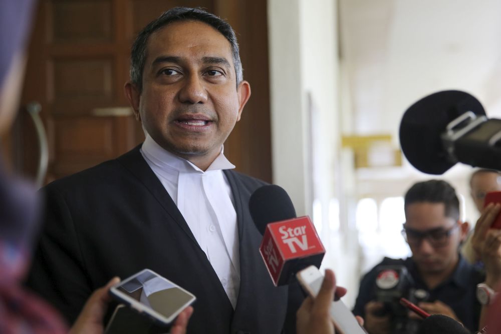 Lawyer Datuk Mohd Hafarizam Harun speaks to reporters outside the courtroom at the KL High Court on April 26, 2018. u00e2u20acu201d Picture by Yusof Mat Isa