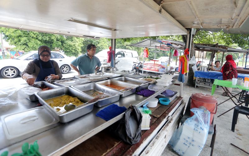 Many in Manjoi are employed as civil servants, while others make a living by setting up small businesses or stalls hawking food, drinks, or fruits and vegetables. — Picture by Farhan Najib