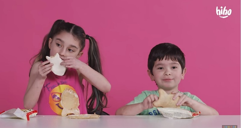 Screen capture of the video showing some of the kids sampling a Korean fish-shaped ice cream sandwich called Samanco.