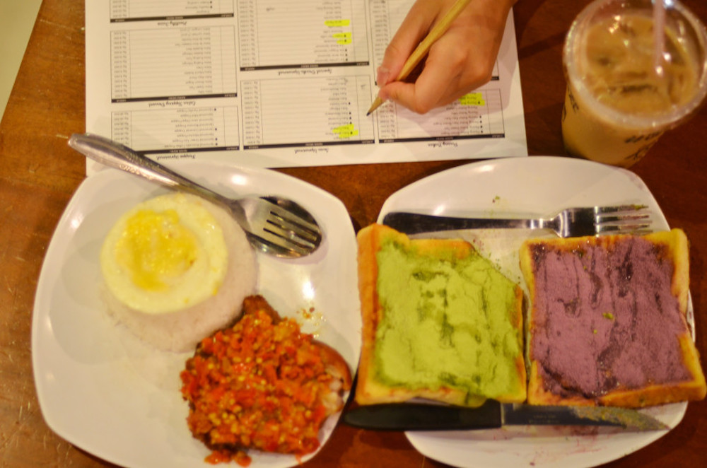 Nasi Ayam Penyet Pedesnya Ga Nyante (Rice With Chicken and Too Hot to Handle Chili Topping), toasts with matcha and taro spread and iced coffee with palm sugar at Warunk Upnormal. — Jakarta Globe pic