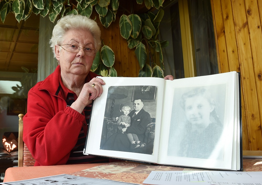 Diethild Heubel holds a family album with an old photo of herself as a child beside her missing father, Gerhard Stuerzebecher in Noerdlingen, southern Germany April 6, 2018. u00e2u20acu201d AFP pic