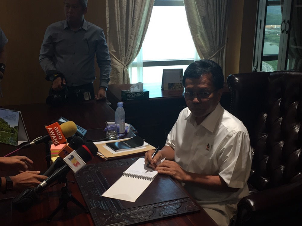 New Sabah Chief Minister Datuk Seri Shafie Apdal  gets down to work at his new office at the state administrative building. u00e2u20acu201d Picture by Julia Chan