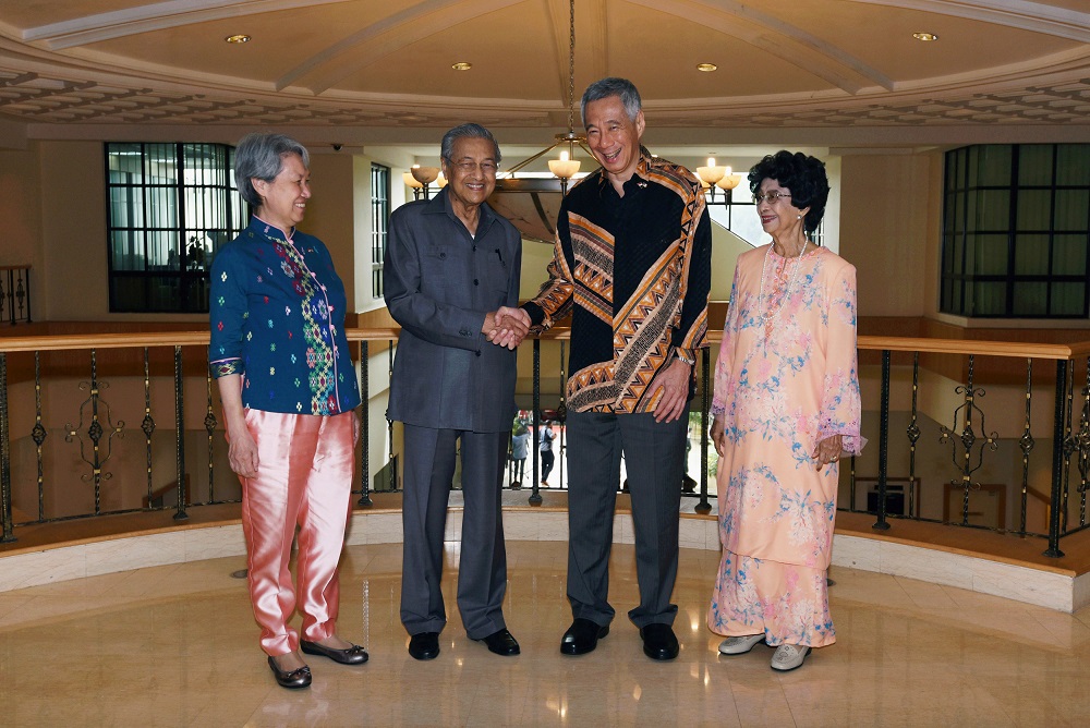 Singaporeu00e2u20acu2122s Prime Minister Lee Hsien Loong shakes hands with Prime Minister Tun Dr Mahathir Mohamad, as Mahathiru00e2u20acu2122s wife Tun Dr Siti Hasmah and Leeu00e2u20acu2122s wife Ho Ching look on prior to their private meeting in Putrajaya May 19, 2018. u00e2u20acu201d Reuters pic