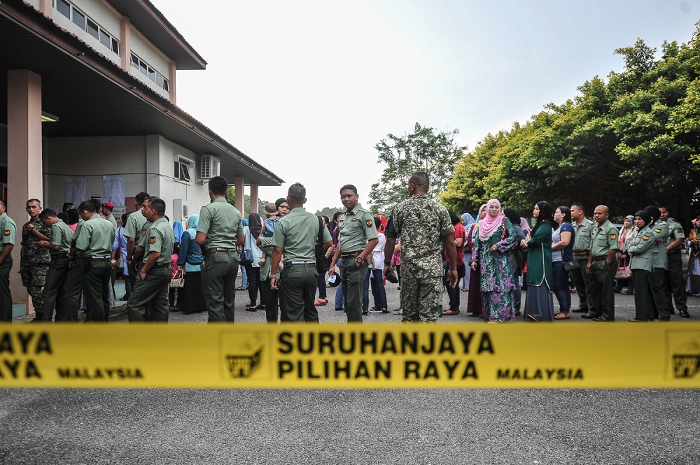Military officers queue to cast their ballots at Kem Mahkota Kluang in Johor May 5, 2018. u00e2u20acu201d Picture by Shafwan Zaidon