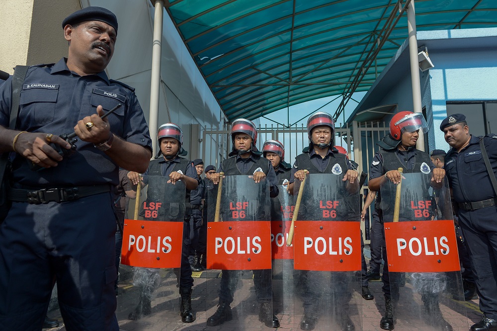 Police officers, including the light strike force, stand guard outside the Sultan Abdul Aziz Shah Airport in Subang Jaya May 12, 2018.
