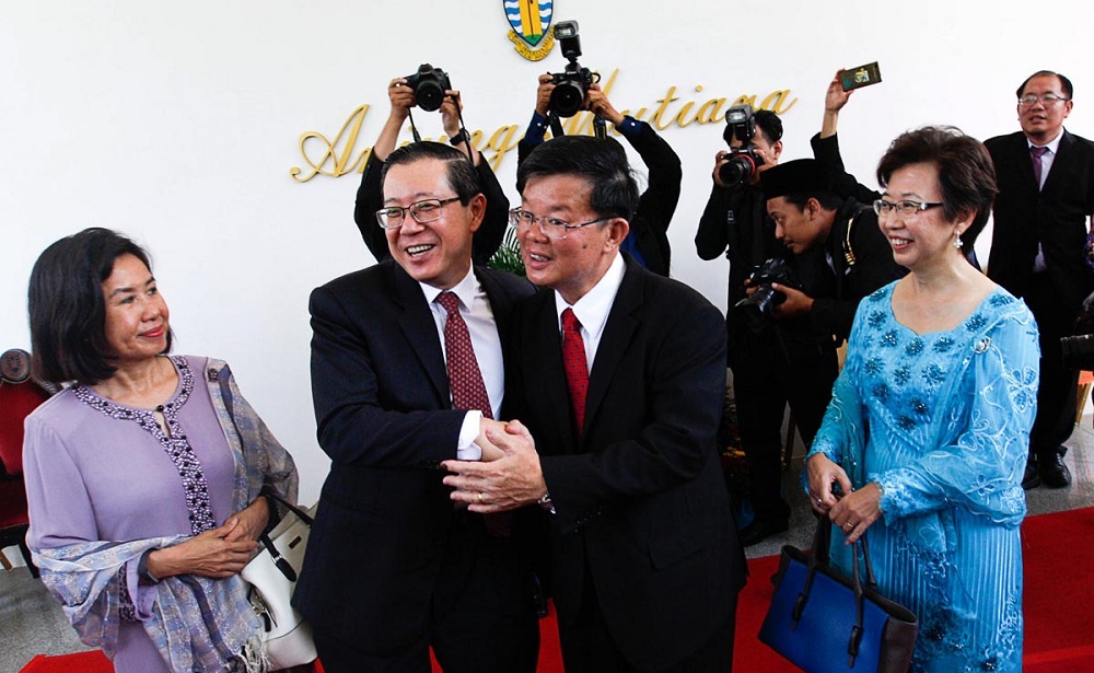 Former Penang chief minister Lim Guan Eng (second left) congratulates Chow Kon Yeow after the latter was appointed as the new Penang chief minister in George Town May 14, 2018.