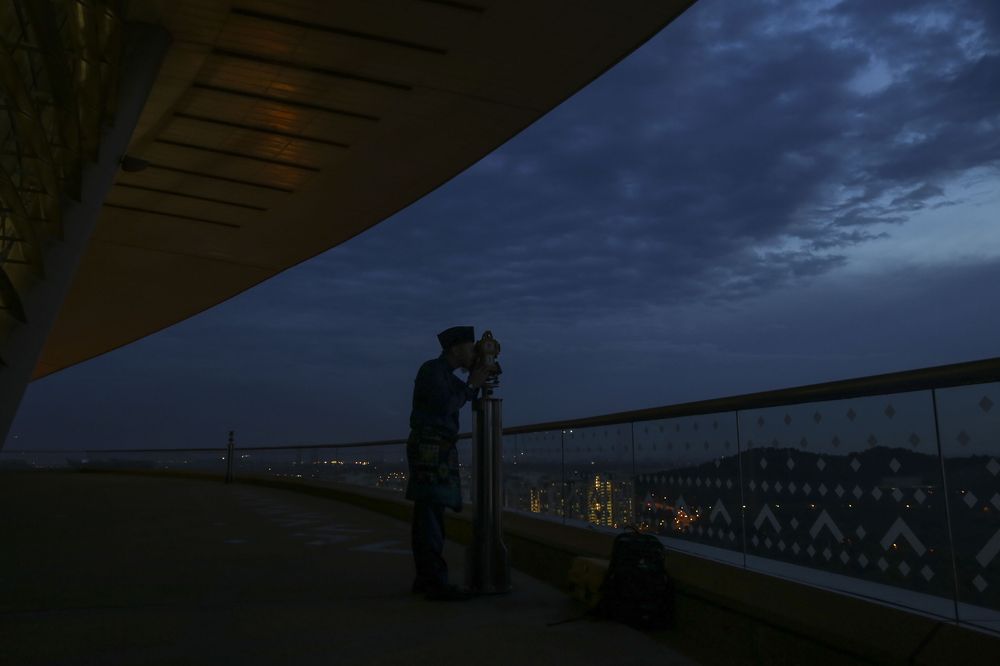 An Islamic religious department officer performing the u00e2u20acu02dcrukyahu00e2u20acu2122 the sighting of the new moon of Ramadan in Putrajaya on May 15, 2018. u00e2u20acu201d Picture by Yusof Mat Isa