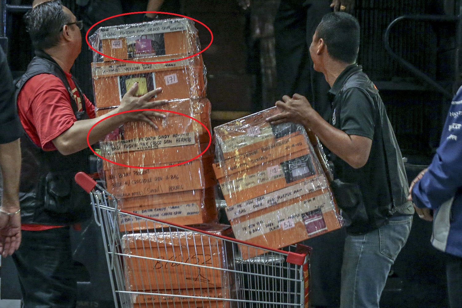 Two fuchsia pink Hermes Birkin bags can be seen labelled among the pile of boxes containing designer bags that were confiscated in last nightu00e2u20acu2122s raid. u00e2u20acu201d Picture by Hari Anggara