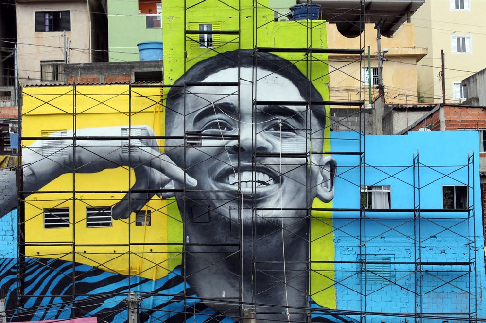 The image of Brazilu00e2u20acu2122s football player Gabriel Jesus is seen on the walls of houses in the neighbourhood he lived in during his childhood in Sao Paulo, Brazil May 16, 2018. u00e2u20acu201d Reuters pic