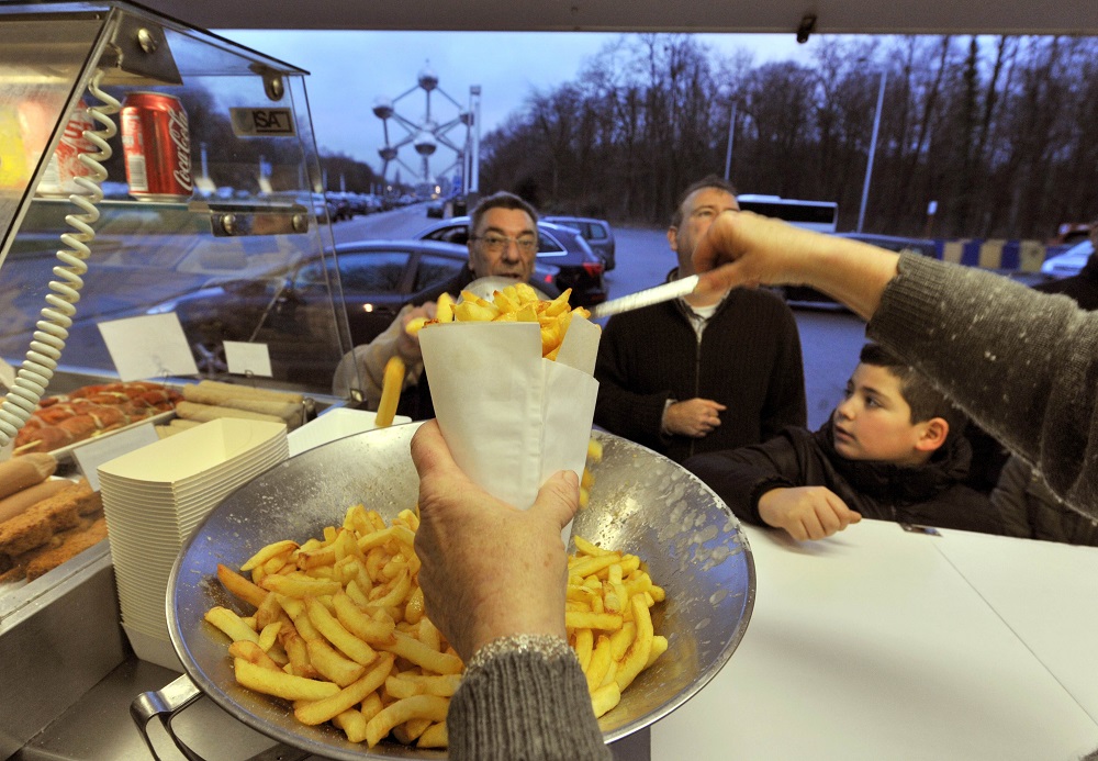 In this file photo taken on January 22, 2011, Josiane Devlaeminck serves Belgian fries to customers at the Atomium u00e2u20acu02dcfritkotu00e2u20acu2122, the Flemish word for fries stand in Brussels. u00e2u20acu201d AFP pic