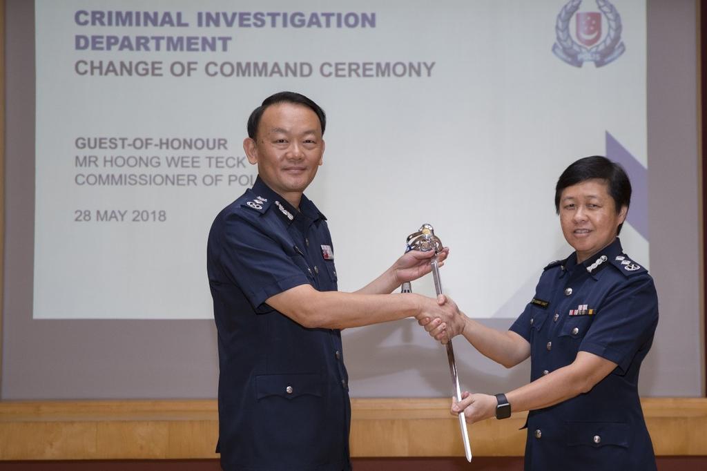 Senior Assistant Commissioner of Police Florence Chua Siew Lian taking over the Command Sword from Commissioner of Police Hoong Wee Teck. u00e2u20acu201d TODAY pic